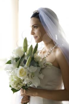 Royalty Free Photo of a Bride Holding a Flower Bouquet