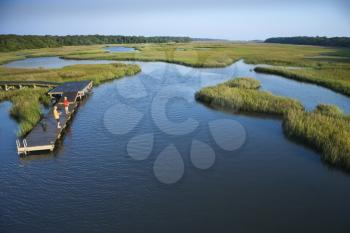 Royalty Free Photo of an Aerial View of Two Teenage Boys Fishing From a Dock in Marshy Lowlands of Bald Head Island, North Carolina