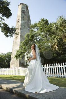 Royalty Free Photo of a Bride Standing Near a Lighthouse