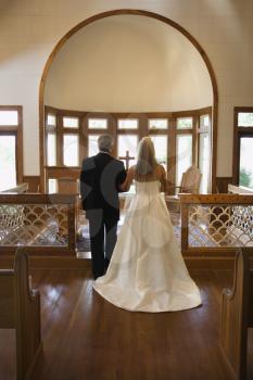 Royalty Free Photo of a Bride and Groom at the Alter of a Church