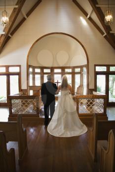 Royalty Free Photo of a Portrait of a Bride and Groom at the Alter of a Church
