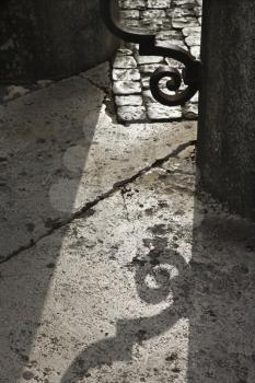 Royalty Free Photo of a Shadow on the Ground From an Iron Gate in Saint Peter's Square, Vatican City, Italy