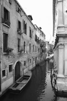 Royalty Free Photo of a Canal With a Boat and Buildings in Venice, Italy