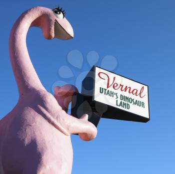 Royalty Free Photo of Pink Dinosaur Holding a Sign for the City of Vernal, Utah