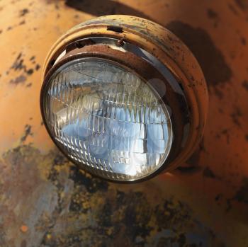Royalty Free Photo of a Headlight of a Scratched Up Rusty Old Pick-Up Truck