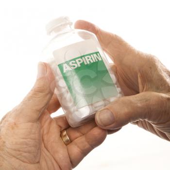 Royalty Free Photo of a Close-Up of Elderly Male Hands Holding an Aspirin Bottle