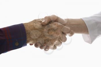 Royalty Free Photo of an Elderly Man Shaking Hands With a Woman
