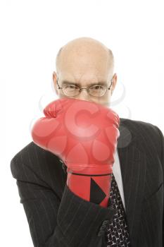 Royalty Free Photo of a Middle-aged Man Holding Up Hand With a Red Boxing Glove up to His Face