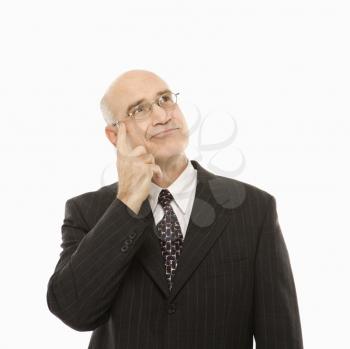 Royalty Free Photo of a Middle-Aged Businessman With Hand to Head Looking Thoughtful
