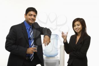 Royalty Free Photo of Businesspeople Standing Talking at a Water Cooler 