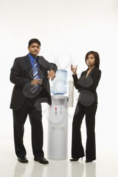 Royalty Free Photo of Businesspeople Standing at a Water Cooler 