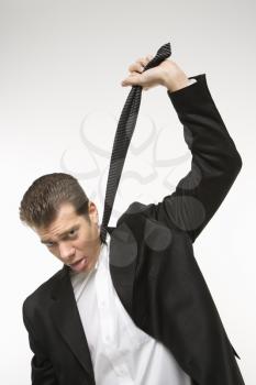 Royalty Free Photo of a Man Pulling His Necktie Out to Choke Himself