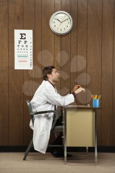 Royalty Free Photo of a Doctor Sitting at a Desk 
