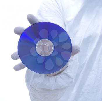 Royalty Free Photo of a Man in Bio-Hazard Suit and Latex Gloves Holding a Compact Disc
