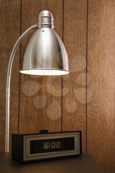 Royalty Free Photo of a Desk Lamp Shining on a Retro Alarm Clock
