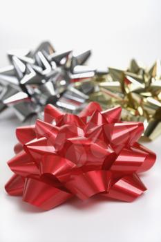 Royalty Free Photo of a Still Life of a Big Shiny Red, Gold and Silver Christmas Bows