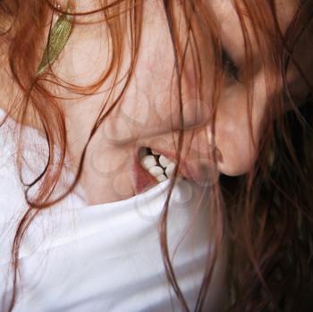 Royalty Free Photo of a Redhead Biting a Pillow