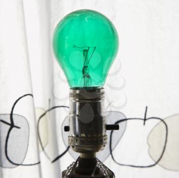 Royalty Free Photo of a a Close-up of a Green Light Bulb in a Lamp