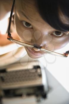 Royalty Free Photo of a Young Woman Looking Up With a Typewriter in the Background
