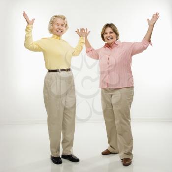 Royalty Free Photo of a Older Women Standing With Arms Raised
