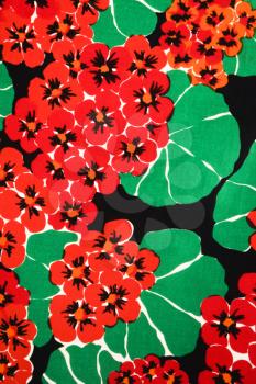 Royalty Free Photo of a Vintage Fabric With Vibrant Red Geraniums and Green Leaves Printed on Polyester