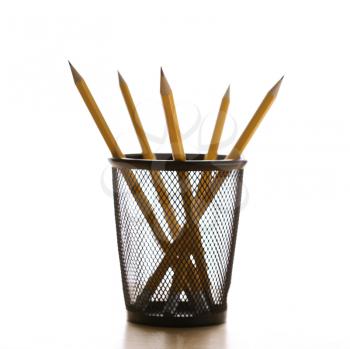 Royalty Free Photo of Five Pencils in a Wire Mesh Pencil Holder