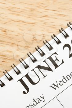 Royalty Free Photo of a Close-up of a Spiral Bound Calendar Displaying the Month of June
