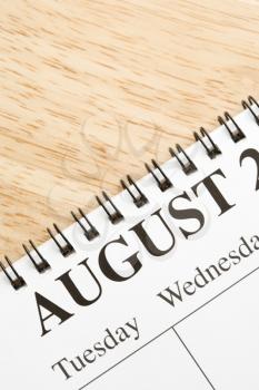 Royalty Free Photo of a Close-up of a Spiral Bound Calendar Displaying the Month of August