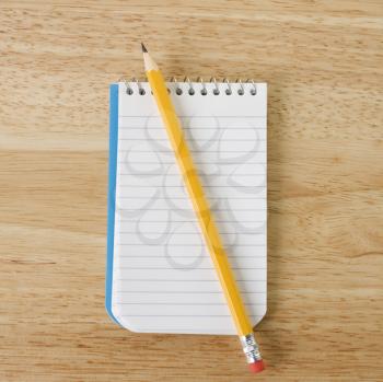 Royalty Free Photo of a Pencil on Top of a Open Spiral Bound Notepad