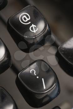 Royalty Free Photo of a Close-up of the At Sign and Question Mark Levers on a Typewriter