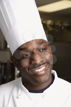 Royalty Free Photo of a Chef Wearing a Uniform Smiling