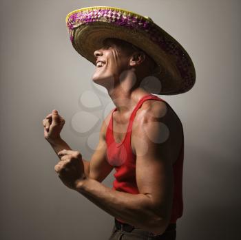 Royalty Free Photo of a Man Wearing a Sombrero and Snapping His Fingers