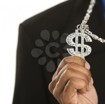 African American man wearing necklace with money sign.