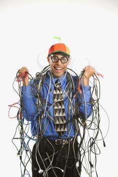African American businessman wrapped in computer cables wearing nerd hat and glasses.