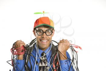 Royalty Free Photo of Businessman Wrapped in Computer Cables Wearing a Propeller Hat