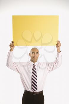 Royalty Free Photo of a Man Holding Up a Blank Sign 