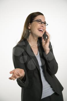 Royalty Free Photo of a Professional Businesswoman Talking on a Cellphone With Hand Out and Smiling