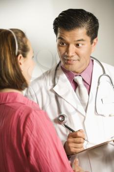 Royalty Free Photo of a Male Doctor Consulting With a Female Patient