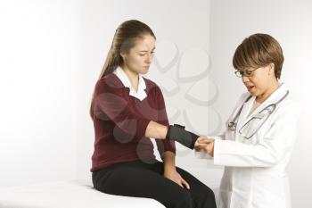 Royalty Free Photo of a Doctor Examining a Female Patient's Wrist
