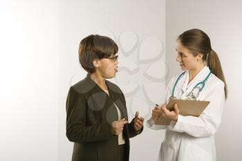Royalty Free Photo of a Doctor Talking to a Female Patient