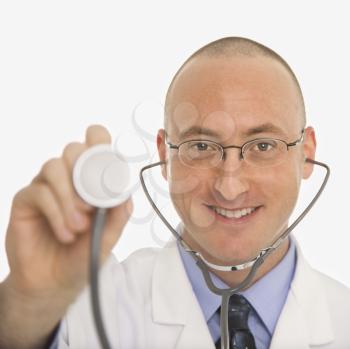 Royalty Free Photo of a Male Physician Holding Up the End of a Stethoscope