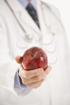 Royalty Free Photo of a Doctor Holding an Apple
