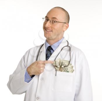 Royalty Free Photo of a Physician With Cash Hanging Out of His Pocket