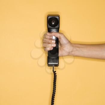 Royalty Free Photo of a Woman Holding Out a Telephone Receiver