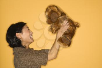 Royalty Free Photo of a Pretty Woman Holding a Brown Teddy Bear