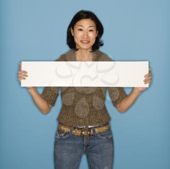Royalty Free Photo of a Pretty Woman Holding Up a Blank Sign