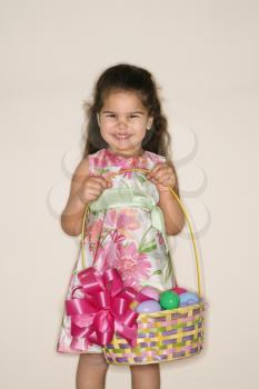 Royalty Free Photo of a Girl Holding an Easter Basket Smiling