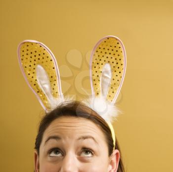Royalty Free Photo of a Woman Wearing Rabbit Ears and Looking Up