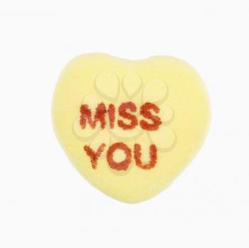Royalty Free Photo of a Yellow Candy Heart That Reads Miss You