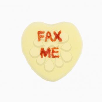 Royalty Free Photo of a Yellow Candy Heart That Reads Fax Me